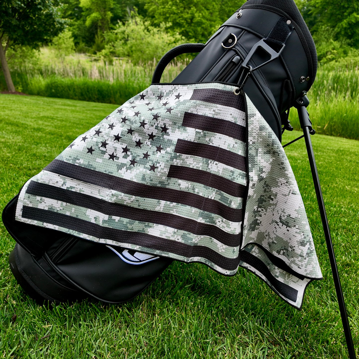 Military digital camo American flag golf towel hanging on a black golf bag with black stars, black stripes, camo print, and patriotic golf towel design.