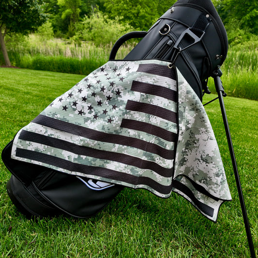 Military digital camo American flag golf towel hanging on a black golf bag with black stars, black stripes, camo print, and patriotic golf towel design.