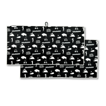 Black Colorado golf towel product image showing a front and back pattern with white Colorado text, mountains, bison, pine trees, golfers, carts, and golf flags.