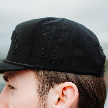 Black Scottsdale tonal performance golf hat side detail with tonal Pin Hunters logo embroidery, perforated side panels, and black rope detail.
