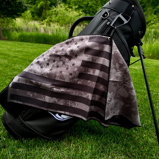 Black USA camo American flag golf towel hanging on a black golf bag with black digital camo, black stars and stripes, and black trim.