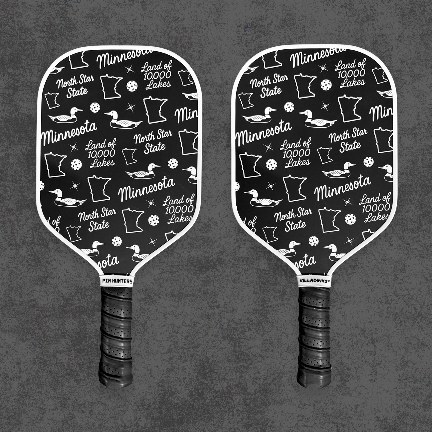 Black and white Minnesota pickleball paddle pair with loon, state outline, North Star State, and Land of 10,000 Lakes pattern.
