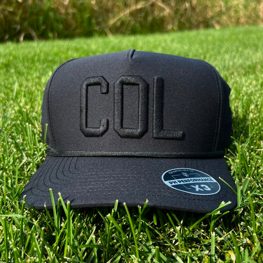 Black Colorado performance golf hat on grass with tonal black raised COL embroidery, black rope, flat brim, and PH Performance X3 sticker.