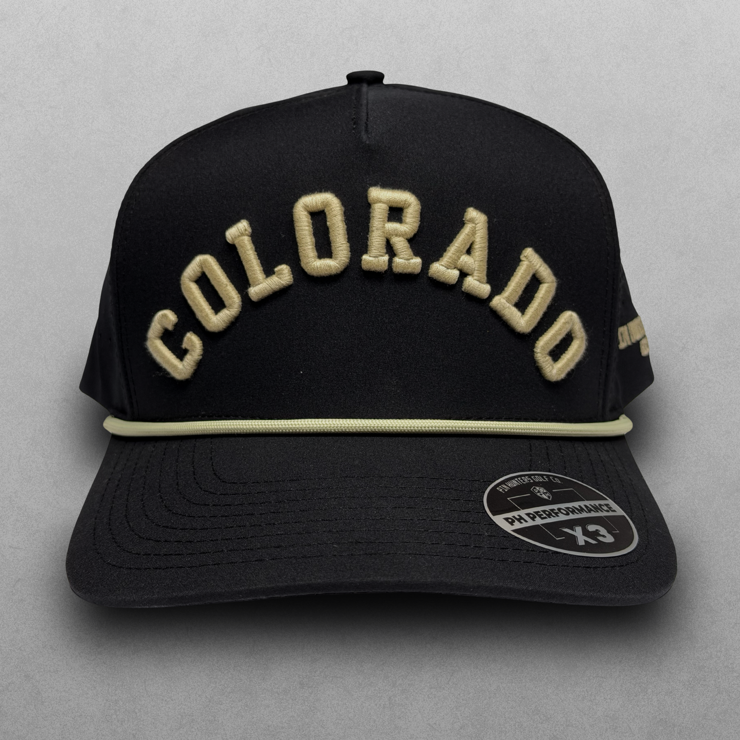 Black Colorado Buffs Boulder performance hat with cream raised arched embroidery, cream rope detail, side embroidery, and PH Performance X3 sticker.