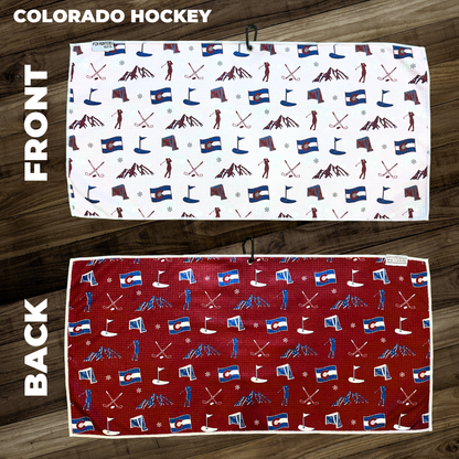 Colorado hockey golf towel layout with Colorado flags, mountains, hockey sticks, snowflakes, golf flags, and golfer icons.