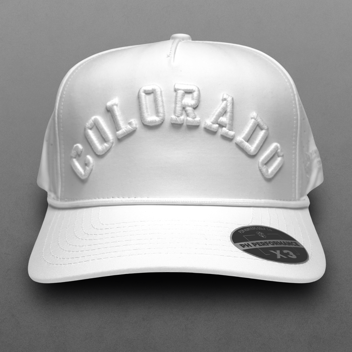 White Colorado performance hat with tonal white raised arched embroidery, white rope detail, perforated side panels, and PH Performance X3 sticker.