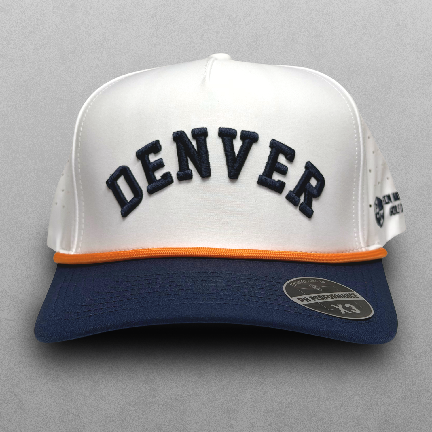 Denver Broncos inspired white performance hat with navy raised DEN embroidery, navy brim, orange rope detail, and PH Performance X3 sticker.