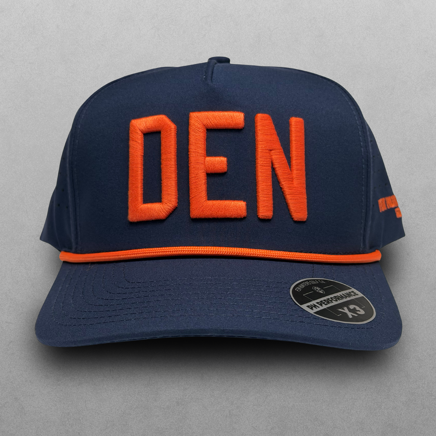 Denver Broncos inspired navy DEN performance hat with orange raised embroidery, orange rope detail, and PH Performance X3 sticker.