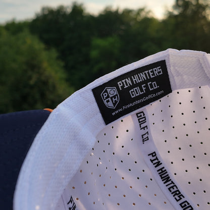 Interior detail of the Denver performance golf hat showing the Pin Hunters Golf Co. label, perforated lining, and branded inner taping.