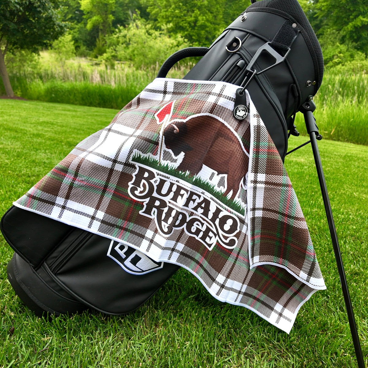 Plaid Buffalo Ridge custom golf towel with bison logo on a black golf bag
