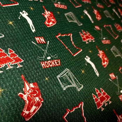 Close up of a green Minnesota Wild inspired hockey golf towel with red and white hockey, state, trees, skates, and golfer graphics.