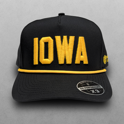 Iowa Hawkeyes inspired black IOWA performance hat with gold raised embroidery, gold rope detail, perforated side panels, and PH Performance X3 sticker.