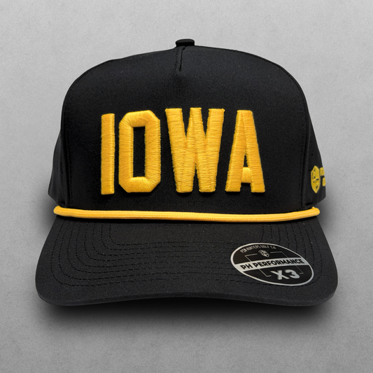 Iowa Hawkeyes inspired black IOWA performance hat with gold raised embroidery, gold rope detail, perforated side panels, and PH Performance X3 sticker.
