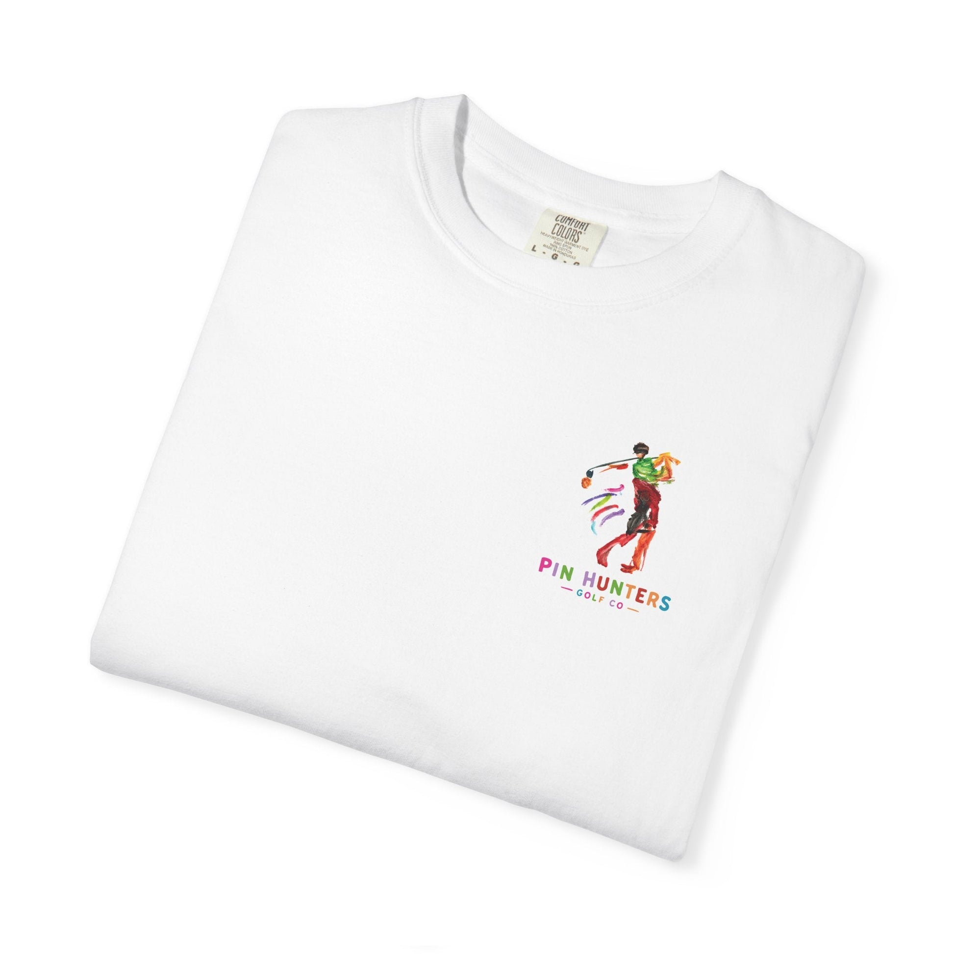Folded white MAC tee showing the colorful Pin Hunters golfer artwork on the chest.