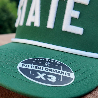 Close up of the Michigan State performance golf hat showing green brim, white rope, raised white STATE embroidery, and PH Performance X3 sticker.