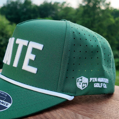 Close up side detail of the Michigan State green performance golf hat with white STATE embroidery, perforated side panel, white rope, and Pin Hunters side logo.