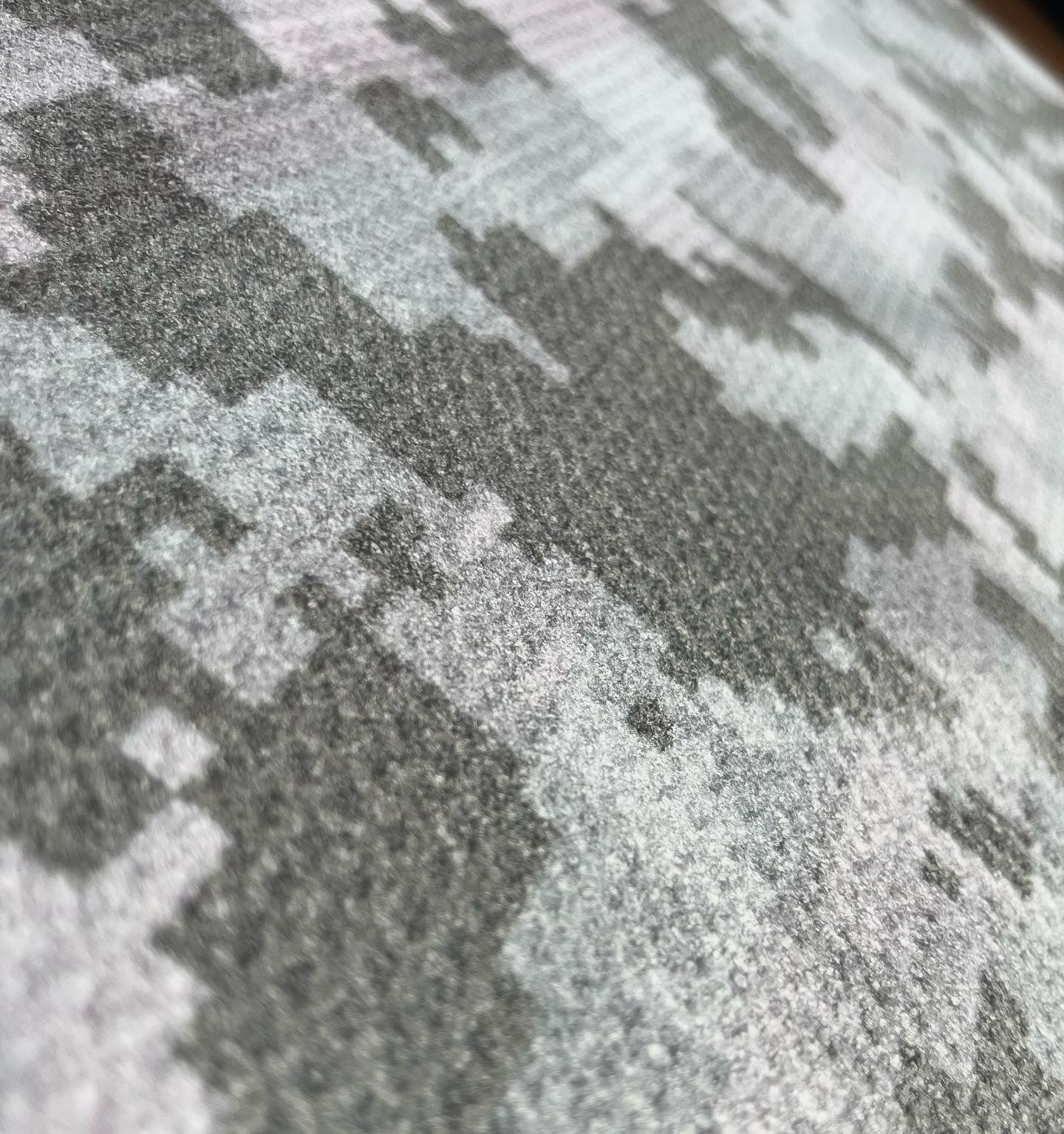 Close up of microfiber waffle golf towel fabric showing printed texture, weave detail, and soft towel surface.