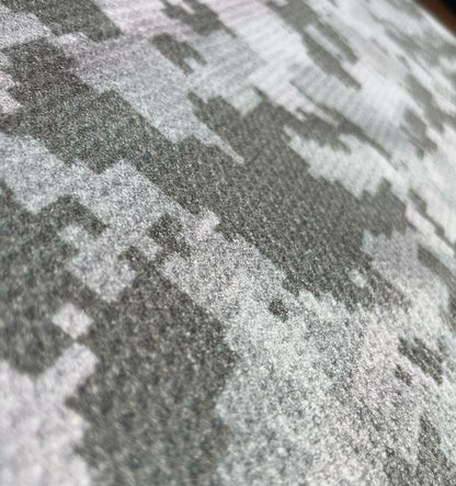 Close up of microfiber waffle golf towel fabric showing printed texture, weave detail, and soft towel surface.