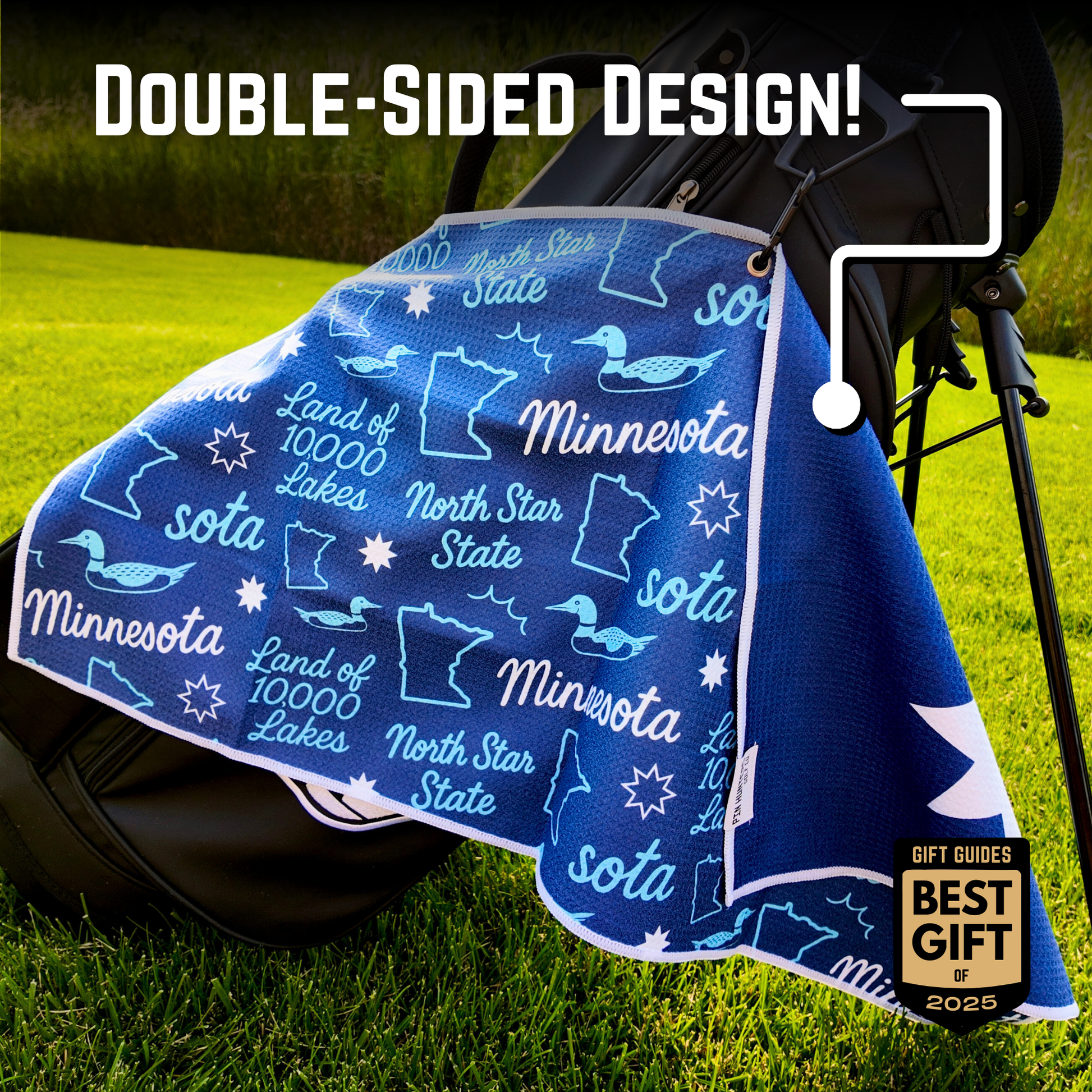 Blue Minnesota flag golf towel hanging on a golf bag with double-sided design callout, state icons, loon graphics, North Star State text, and Best Gift of 2025 badge.
