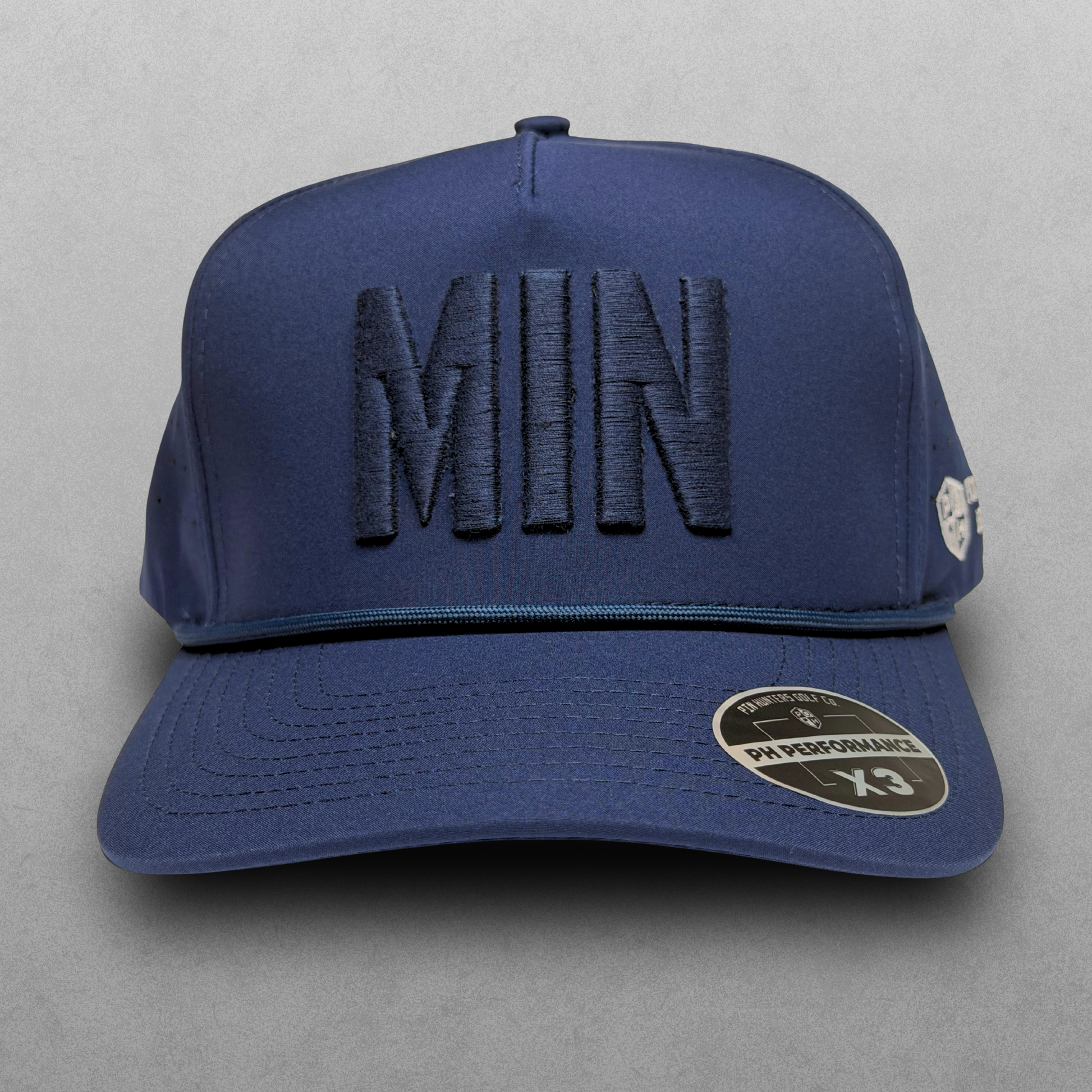 Minnesota Twins inspired navy tonal MIN performance hat with matching raised embroidery, navy rope detail, and PH Performance X3 sticker.