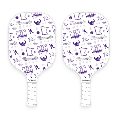 Minnesota Vikings pickleball paddle pair with purple MIN pattern, football icons, helmet graphics, snowflakes, and white handles.