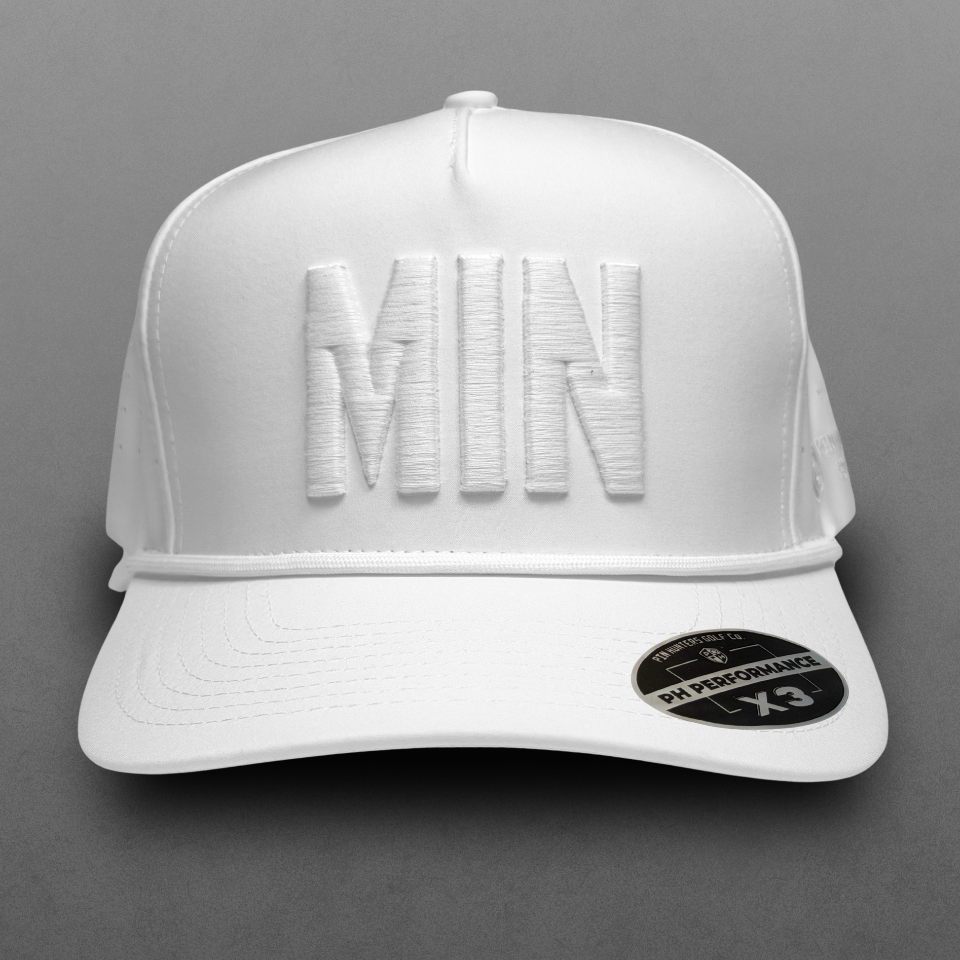 White Minnesota performance hat with tonal white MIN raised embroidery, white rope detail, perforated side panels, and PH Performance X3 sticker.