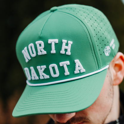 Green North Dakota performance hat with white raised embroidery, white rope detail, perforated side panels, and side logo embroidery.