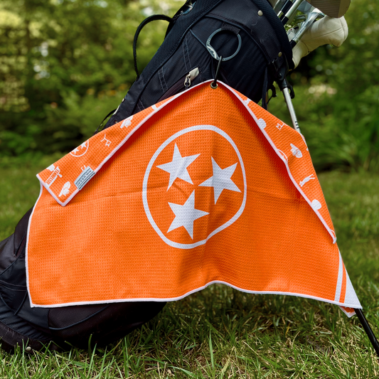 Orange Tennessee flag golf towel hanging from a golf bag with a large white TriStar front design and Tennessee themed back pattern.