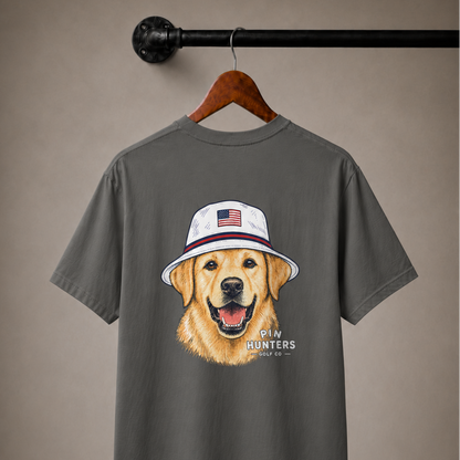Pepper gray Pin Hunters Colby Tee on a wooden hanger with golden retriever bucket hat artwork and Pin Hunters Golf Co. logo.