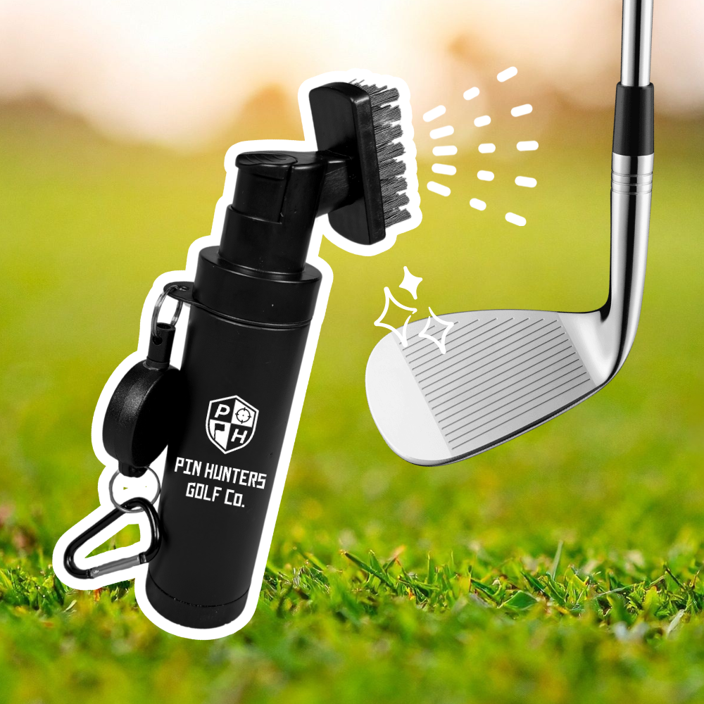 Pin Hunters Golf Co. scrub brush shown next to a golf club face with spray and scrub graphics on a grass background.