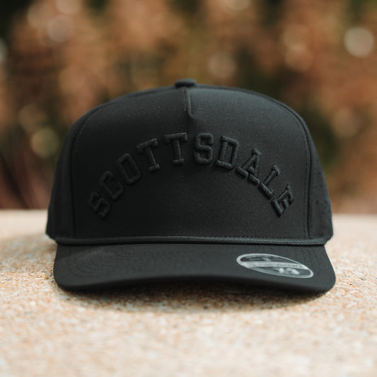 Blackout Scottsdale performance hat with tonal black raised embroidery, black rope, flat brim, and PH Performance X3 sticker.