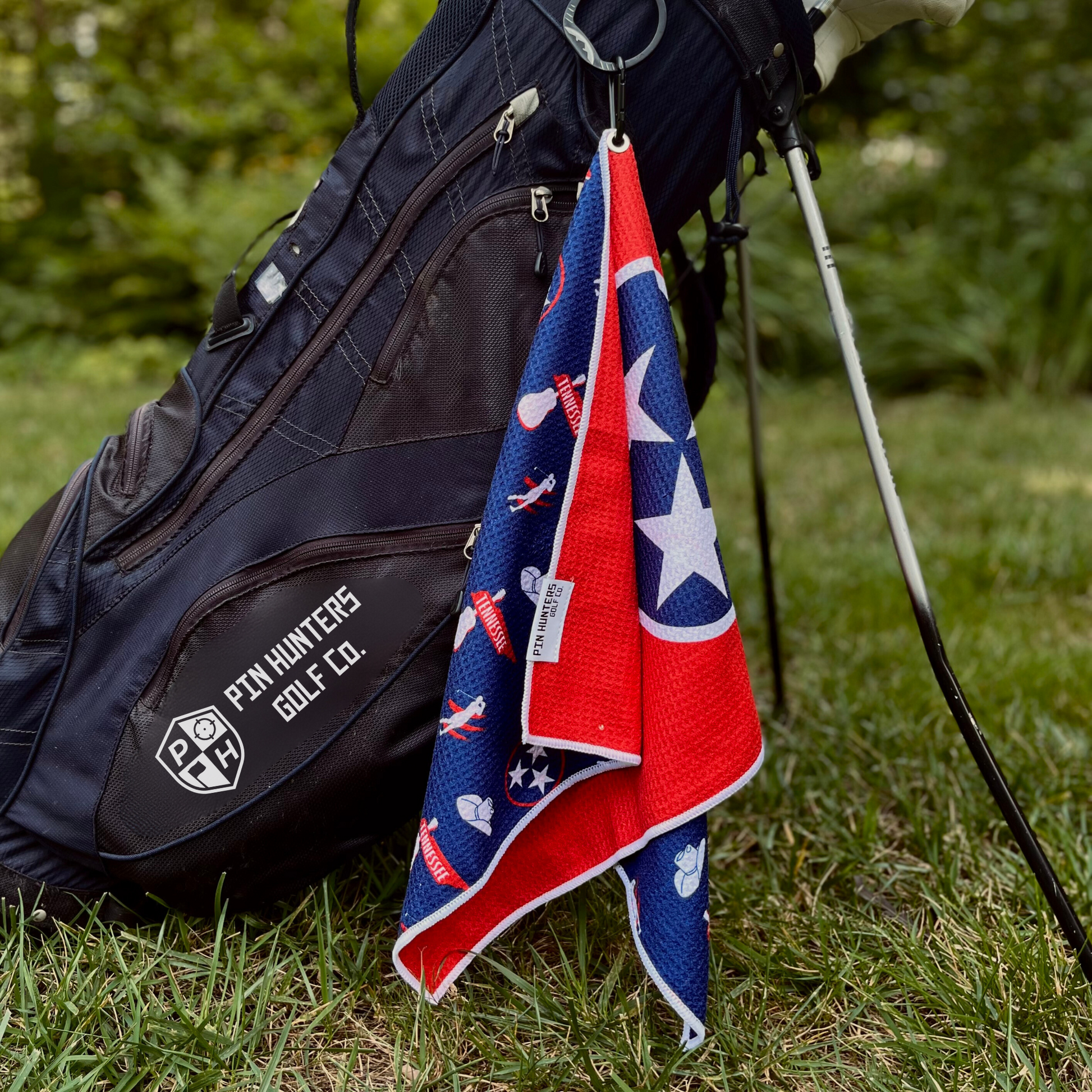 Tennessee flag inspired golf towel hanging from a golf bag with red, blue, white, and TriStar graphics visible.
