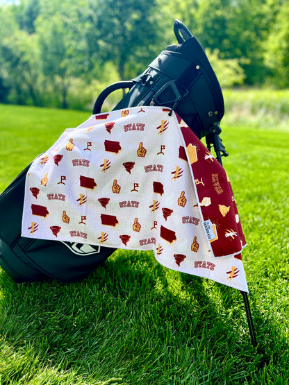 White Iowa State inspired golf towel with cardinal and gold Iowa outline, cyclone, foam finger, golfer, and golf flag graphics.