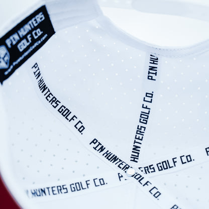 White Pin Hunters performance golf hat interior with branded seam tape, perforated panels, black inner label, and clean structured construction.