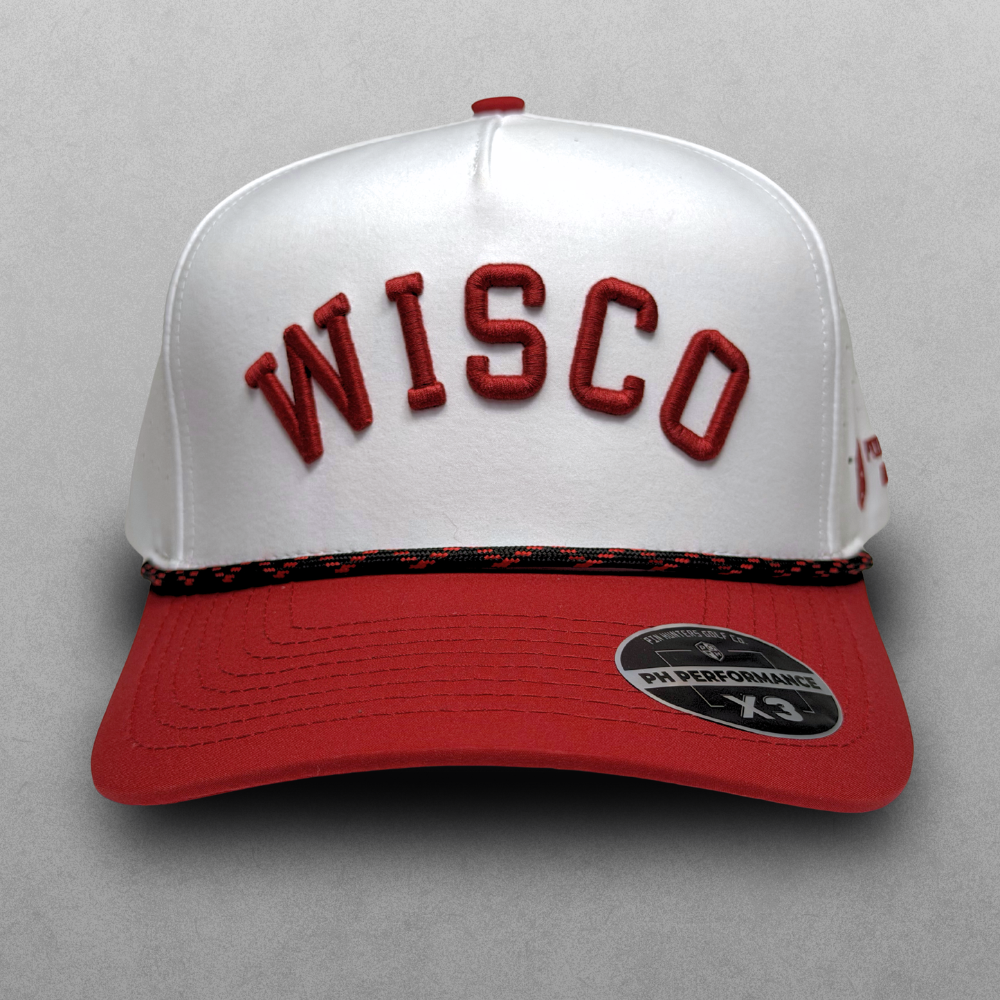 Wisconsin Badgers inspired white Wisco performance hat with red raised embroidery, red brim, black and red rope detail, and PH Performance X3 sticker.