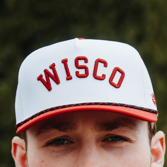 Wisconsin Badgers WISCO performance hat lifestyle view with white crown, red raised embroidery, red brim, and black speckled rope.